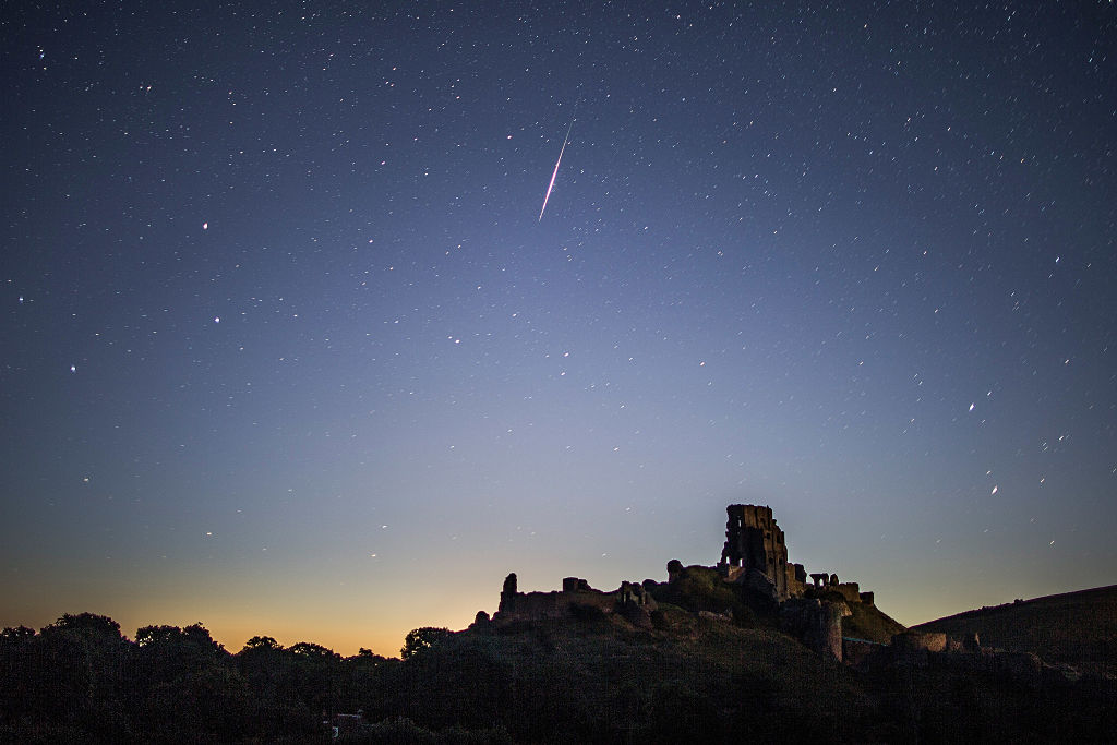 A Perseid meteor flashes across the night sky above Corfe Castle Photo by Dan KitwoodGetty Images
