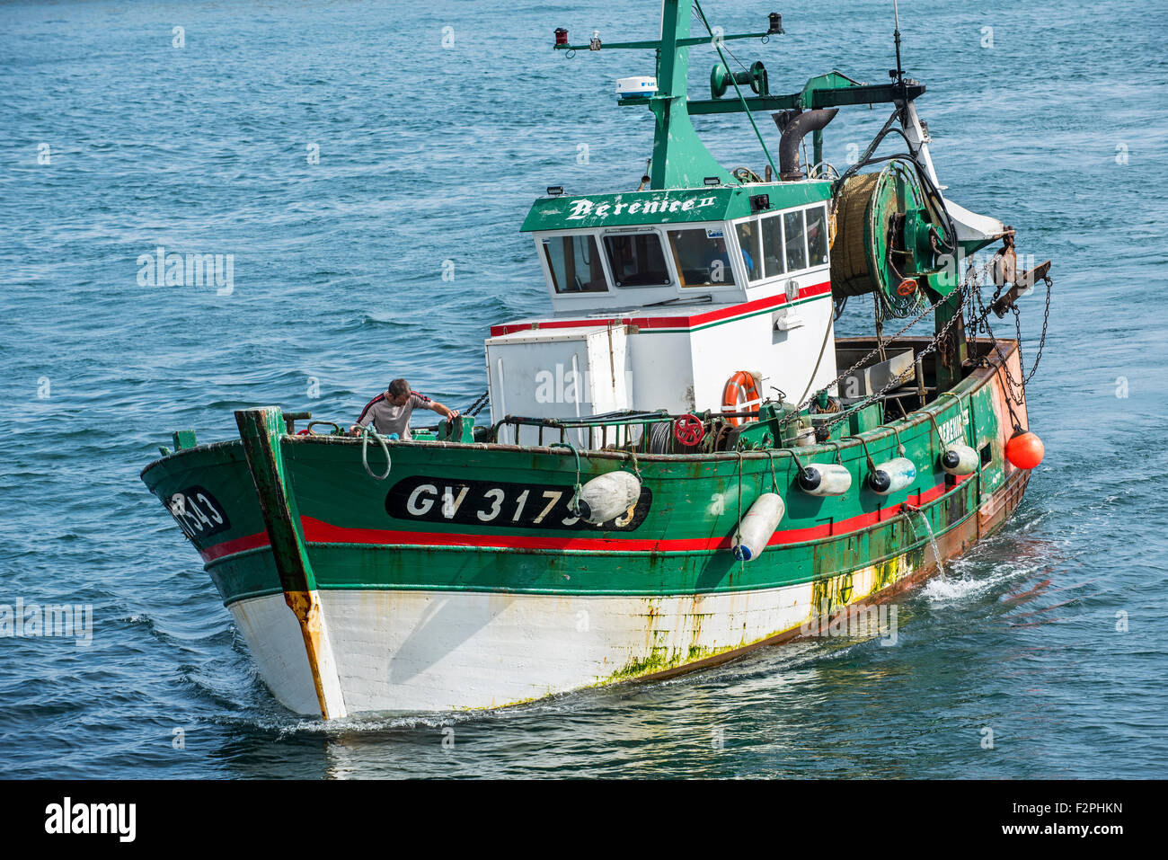 Fisherman on board of green wooden trawler fishing boat at sea Stock Photo  - Alamy